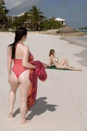 Plump female Christy Mark and her big boobed friend have lesbian sex on beach on fanspics.com