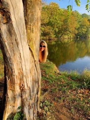 Blonde amateur Sweet Susi models naked in black leather boots near a lake on fanspics.com