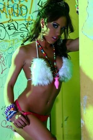 Hot MILF Capri Cavanni peels off her bikini amid graffiti in furry boots on fanspics.com
