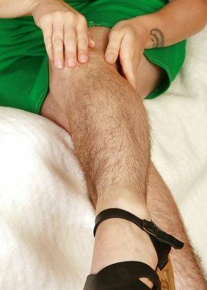 Redhead mature slut with hairy legs and private parts stripping down on fanspics.com