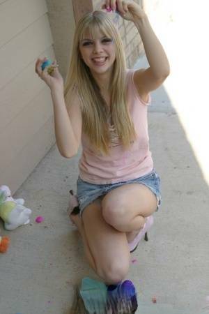 Sweet blonde teen Jana Jordan flashes upskirt panties while eating chocolate - Jordan on fanspics.com