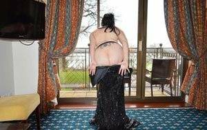 Over 30 amateur Barby Slut slips off a long gown to pose nude in nylons on fanspics.com