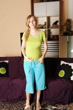 Smiley pregnant amateur with puffy nipples and hairy gash getting naked on fanspics.com