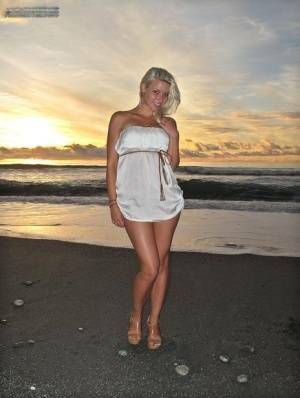 Hot blonde Anikka Albrite strips naked at the beach before nude hitchhiking on fanspics.com