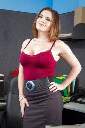 Secretary Krissy Lynn shows her fuckable booty in the office on fanspics.com