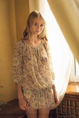 Cute blonde teen Nancy A slips off her floral dress to model naked on fanspics.com