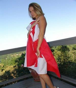 Canadian teen Karen wraps her naked body in a flag on her back deck on fanspics.com