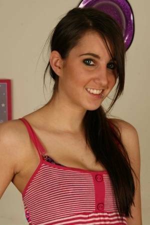 Young brunette Stacy H gets completely naked on a wooden table on fanspics.com