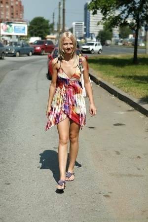 Charming teen blonde posing solo in a lovesome dress outdoor on fanspics.com