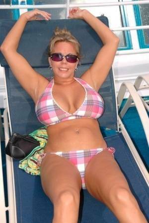 Hugely busty Amber Lynn Bach doffs her bikini to spread her legs wide nude on fanspics.com