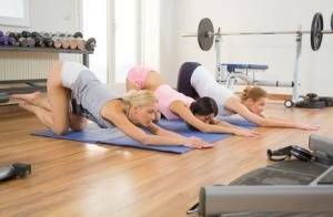 Young girls stretch out on yoga mats before commencing a lesbian threesome on fanspics.com