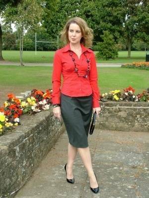 Fully clothed woman steps out of a stiletto heel while visiting a public park on fanspics.com