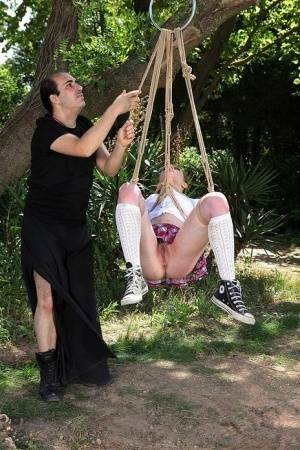 Schoolgirl Samantha Bentley finds herself suspended from ropes in the woods on fanspics.com