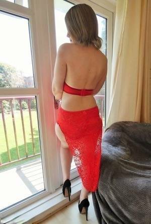 Leggy amateur Posh Sophia works clear of a revealing dress to stand naked on fanspics.com