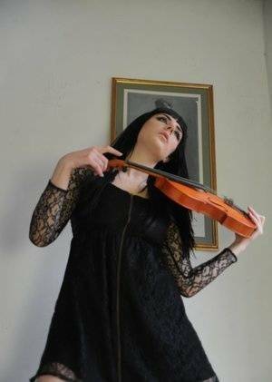 Dark haired violin player Sam Bentley strikes great poses while getting naked on fanspics.com