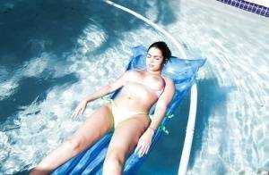 Brunette babe model Ada S going topless on air mattress in swimming pool on fanspics.com