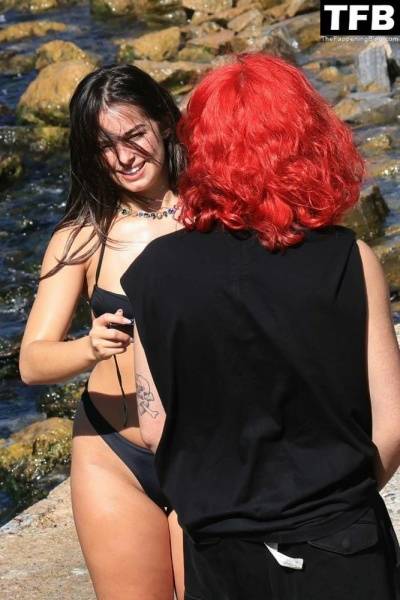 Addison Rae Displays Her Curves in a Black Bikini on Holiday with Omer Fedi on Lake Como on fanspics.com