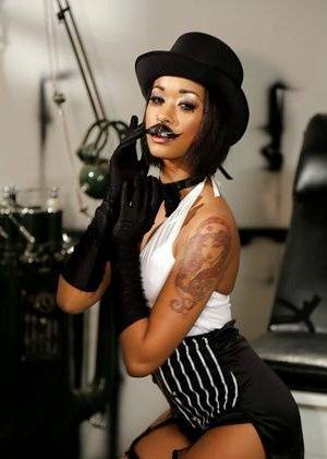 Ebony pornstar Skin Diamond strutting in vintage hat and long gloves on fanspics.com